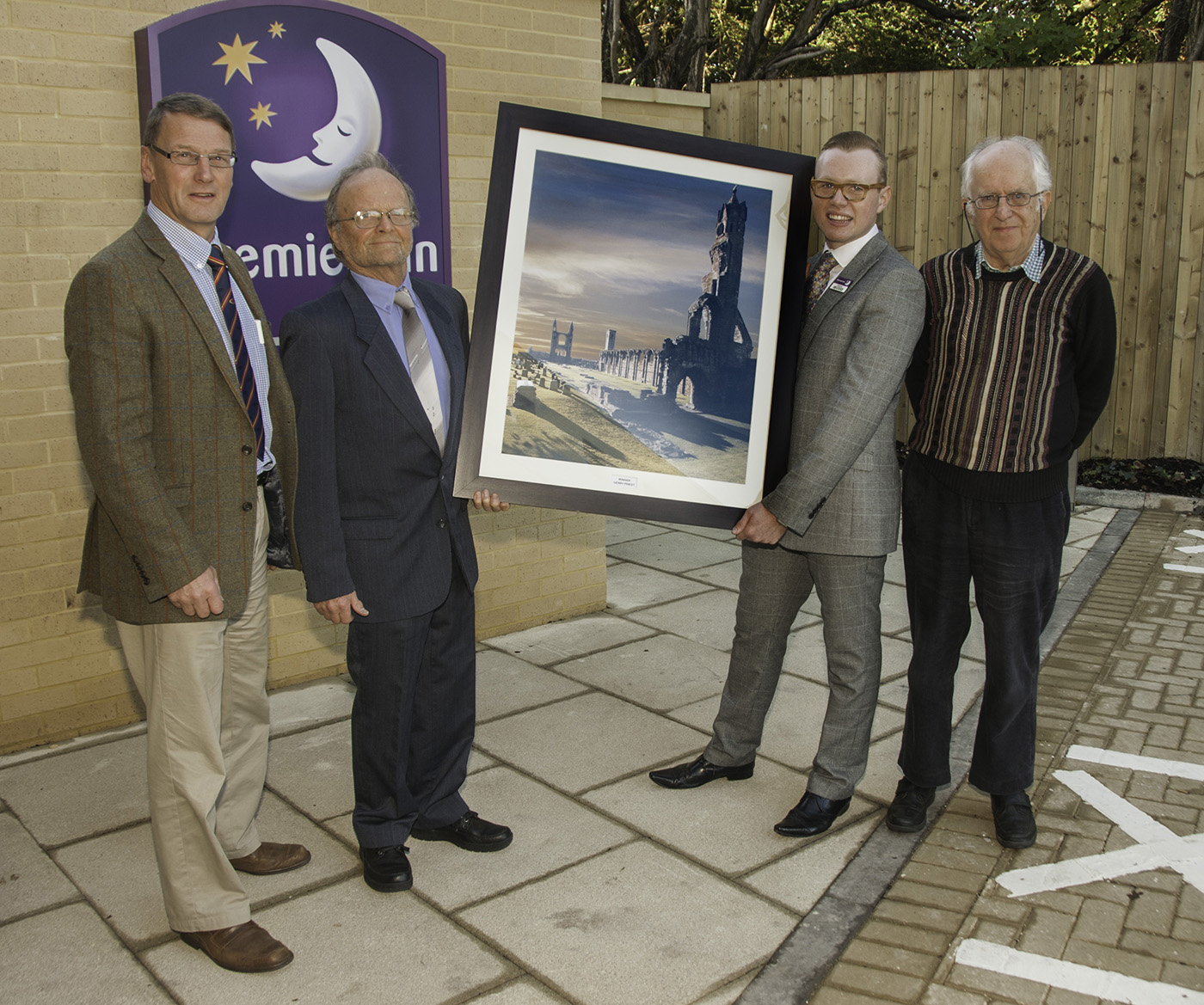 Chris Reekie, Gerry Priest, Premier Inn's manager, and Frank Riddell with the winning photograph. 